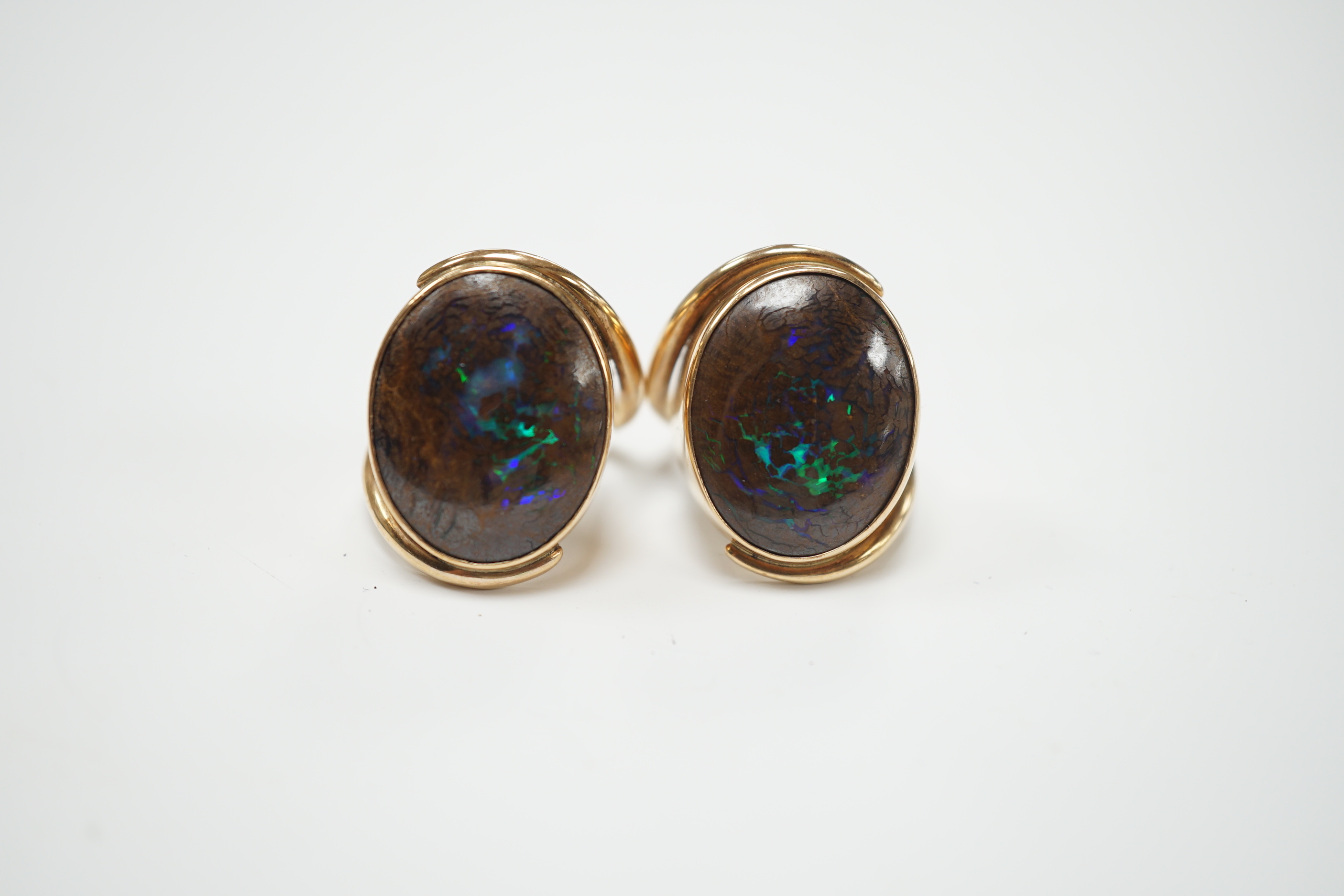 A pair of yellow metal and oval boulder opal set dress rings, both size M, gross weight 20 grams.